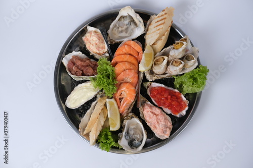 a plate of assorted seafood on a white background