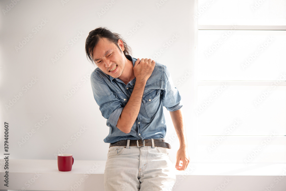 asian guy have serious problem on his shoulder asian guy have serious problem on his shoulder