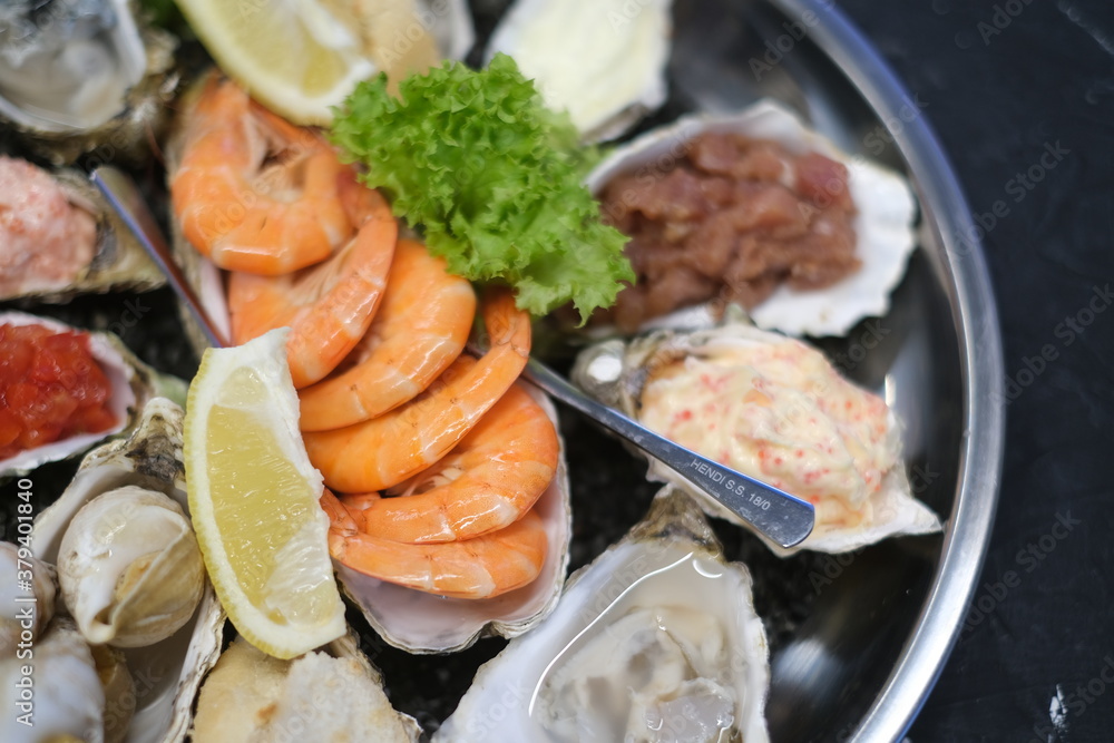 a plate of assorted seafood on a white background close-up a plate of assorted seafood on a white background close-up