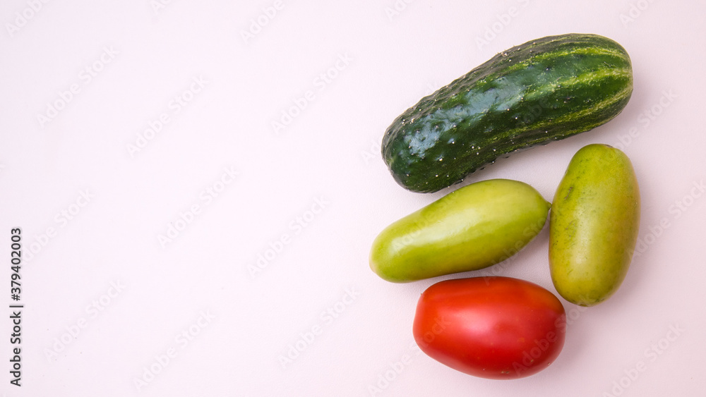 Cucumber, green and red tomatoes, close-up white background