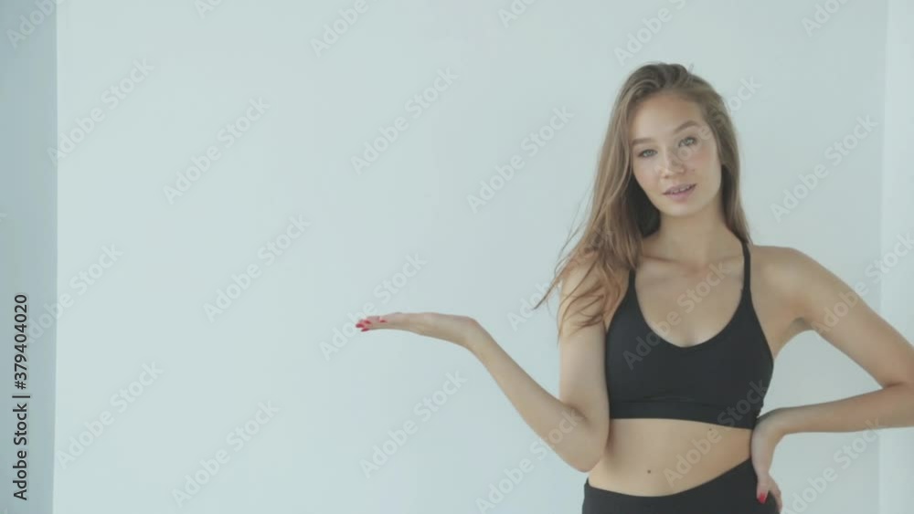Close-up portrait of a sporty girl with makeup. The girl smiles and laughs, looking at the camera on a white background. Close-up portrait of a sporty girl with makeup. The girl smiles and laughs, looking at the camera on a white background.