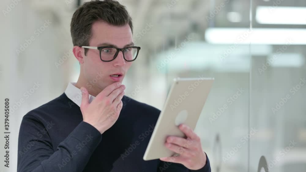 Young Businessman Reacting to Loss on Tablet Young Businessman Reacting to Loss on Tablet