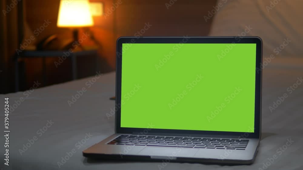 4K : A laptop computer with a key green screen set on work office table. 4K : A laptop computer with a key green screen set on work office table.
