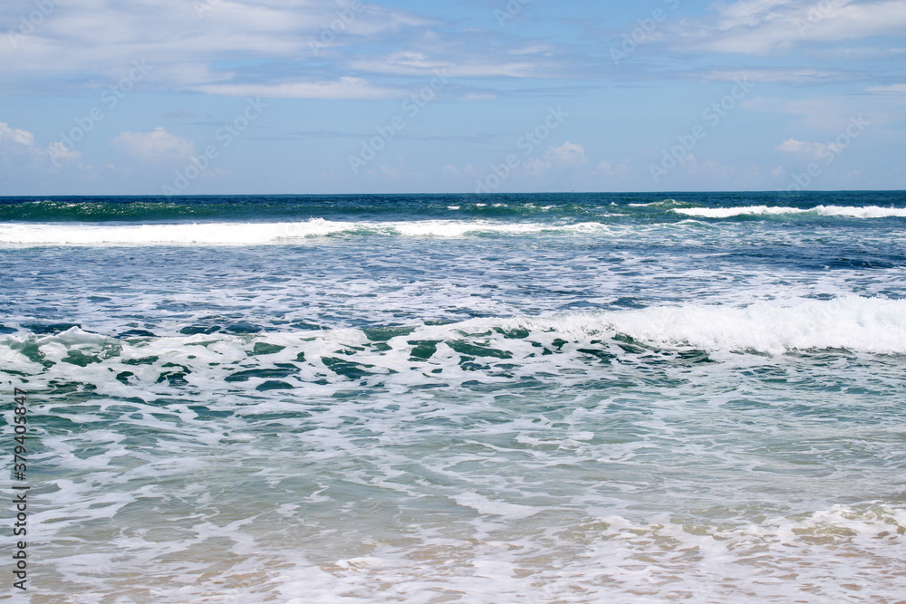 The foam of the waves in the sea that decorates the seashore in summer. Holidays with an atmosphere like this are very enjoyable The foam of the waves in the sea that decorates the seashore in summer. Holidays with an atmosphere like this are very enjoyable