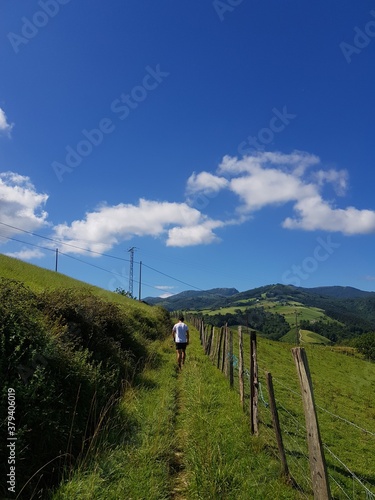 unrecognozible young man walking in the contryside photo