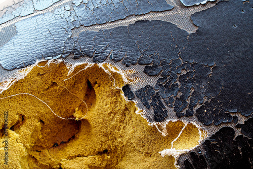 Close up of lack old leather seat .Abstract background of torn old leather sofa
