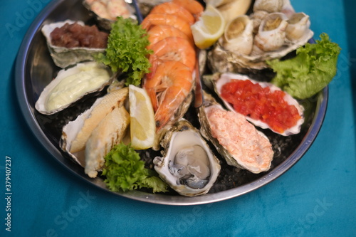 a plate of assorted seafood on a blue background in top view