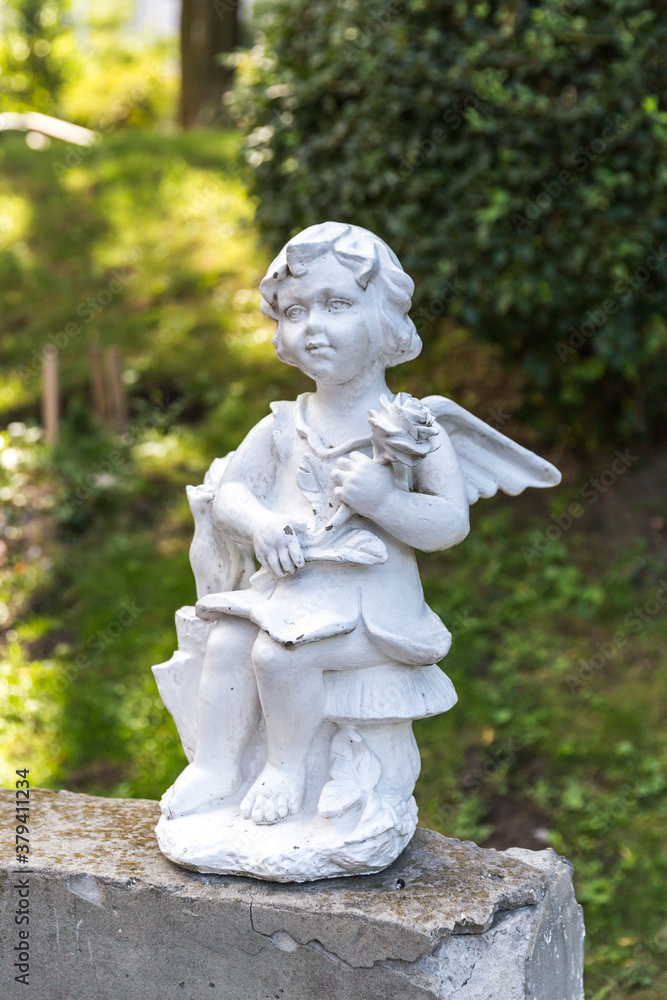 Fototapeta premium Little angel statue in the park.