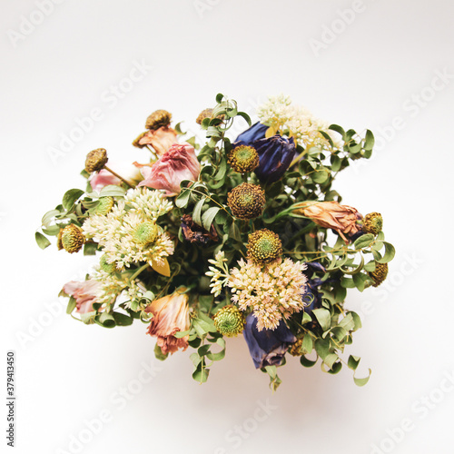 Art arrangement of different dried wildflowers in bouquet in vase
