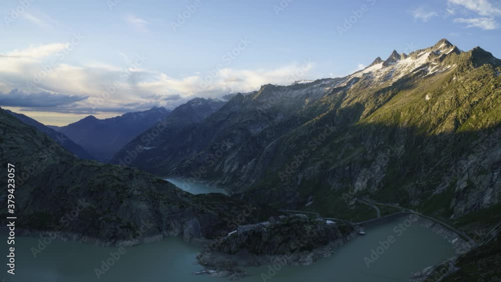 Grimsel Hospiz By The Grimsel Mountain Pass On Sunset - Stunning Landscape Of Lake Grimsel (Grimselsee) In The Canton Of Berne, Switzerland. -time lapse Grimsel Hospiz By The Grimsel Mountain Pass On Sunset - Stunning Landscape Of Lake Grimsel (Grimselsee) In The Canton Of Berne, Switzerland. -time lapse