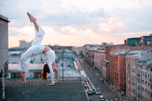 girl doing gymnastics exercise on the roof