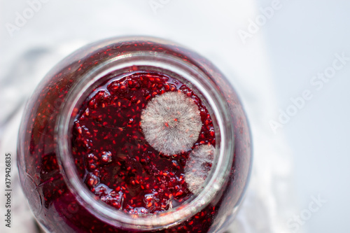 Mold in a jar of raspberry jam. Hazardous to health.