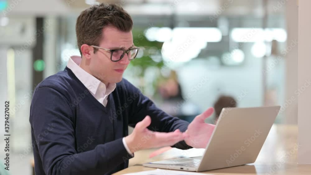 Loss, Young Businessman reacting to Failure on Laptop Loss, Young Businessman reacting to Failure on Laptop