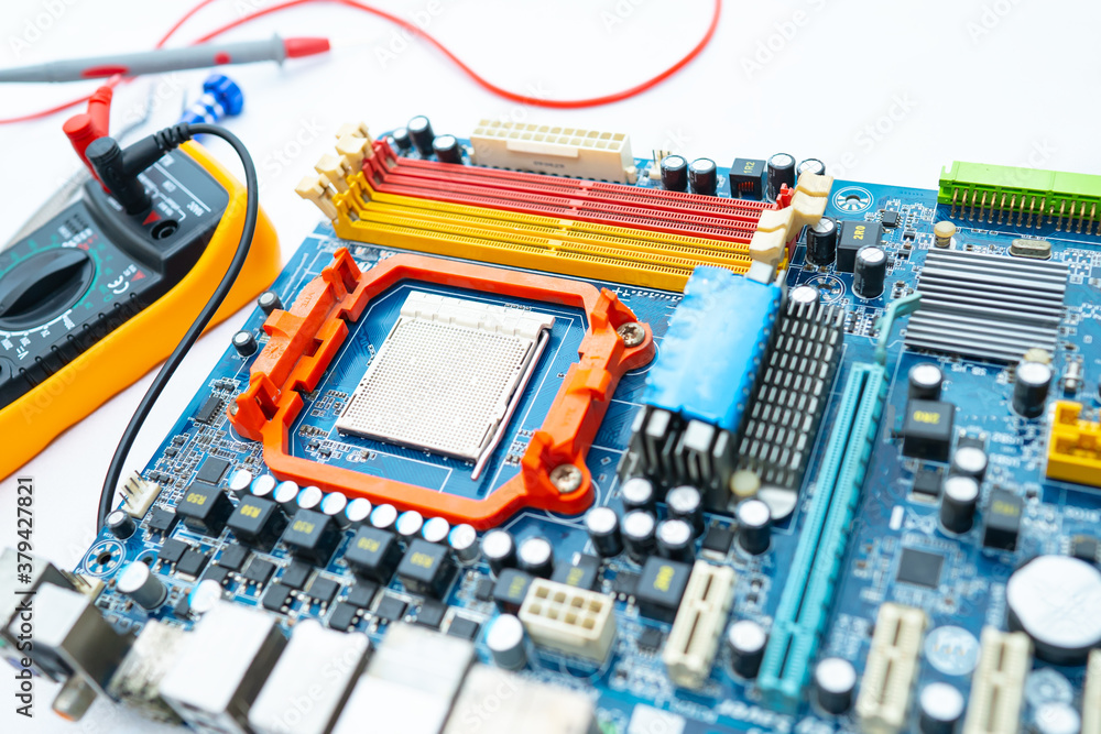 Multimeter with main board, maintenance, repairing and checking computer hardware concept. Multimeter with main board, maintenance, repairing and checking computer hardware concept.