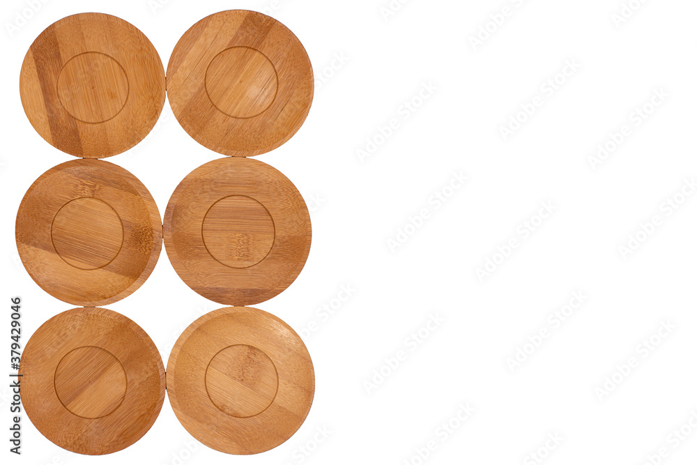 Bamboo saucers arranged in various order, with space to insert letters of text