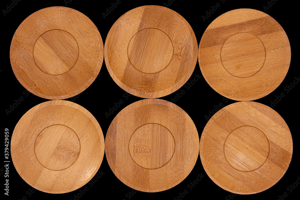 Bamboo saucers arranged in various order, with space to insert letters of text