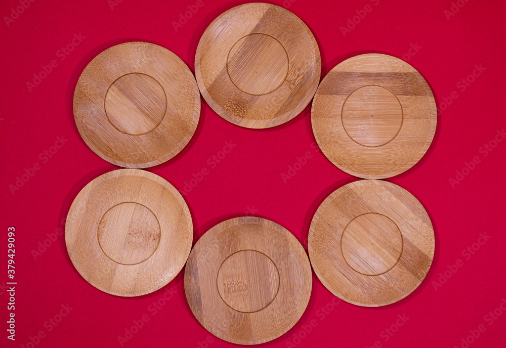 Bamboo saucers arranged in various order, with space to insert letters of text