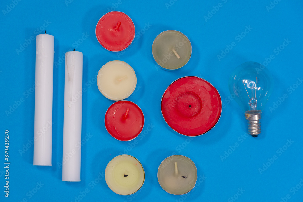 Close up of candles and electric lamps. Lighting concept