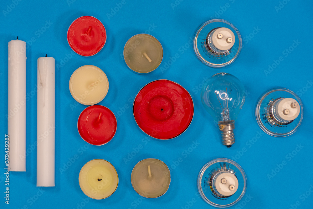 Close up of candles and electric lamps. Lighting concept