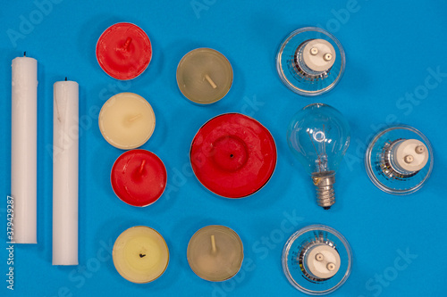 Close up of candles and electric lamps. Lighting concept
