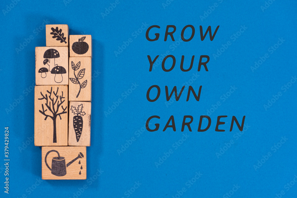 Wooden rectangles and cubes with figures relating to gardening and the garden