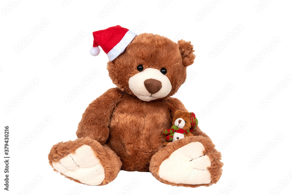 Obraz premium Plush brown bear wearing Santa Claus hat holding small kid. Christmas and New Year celebration. Family winter holidays warmth and love. Plaything for children, present gifts for kids on xmas