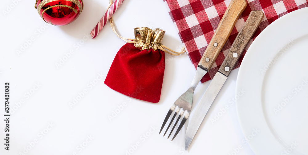 Empty white plate and Christmas ornament isolated on white background Christmas dinner concept. Empty white plate and Christmas ornament isolated on white background Christmas dinner concept.
