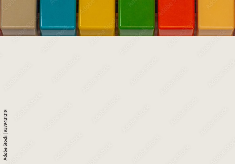 Colorful keys of a toy keyboards with space for writing