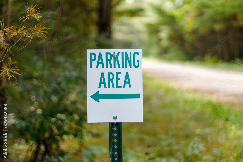 Sign indicating parking area in a rural woodland area
Sign indicating parking area in a rural woodland area