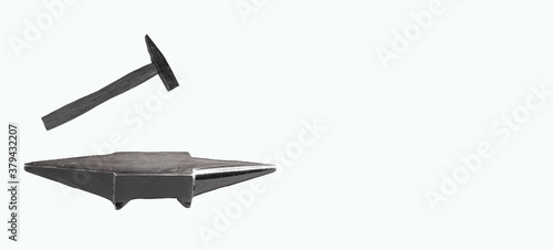 Anvil and hammer isolated on white background with space for writing