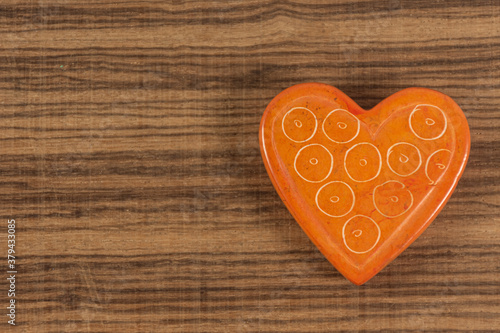 Orange heart on background with space for writing