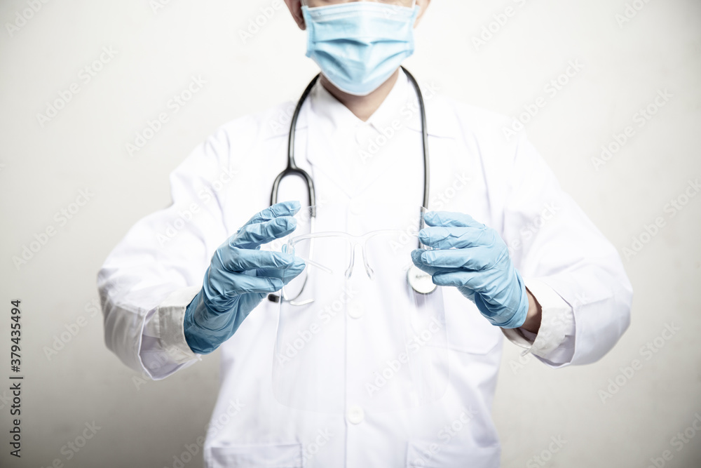 Doctor Man on blur hospital laboratory panoramic blue background. COVID-19 virus epidemic outbreak to Coronavirus pandemic disease global recession wide concept for social scientist vaccine Doctor Man on blur hospital laboratory panoramic blue background. COVID-19 virus epidemic outbreak to Coronavirus pandemic disease global recession wide concept for social scientist vaccine
