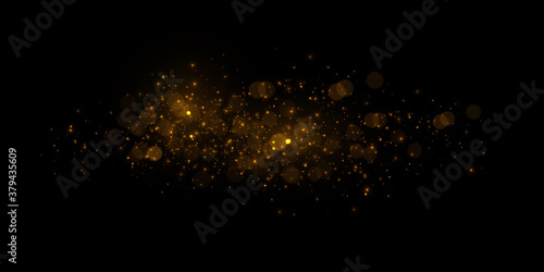 Transparent golden light effect. Magical sparkles isolated on black background.