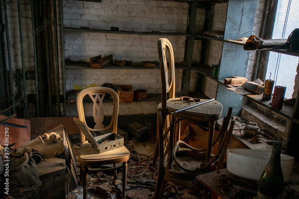 A Room in an Abandoned Building With Two Chairs Full of Debris and Very Old Objects