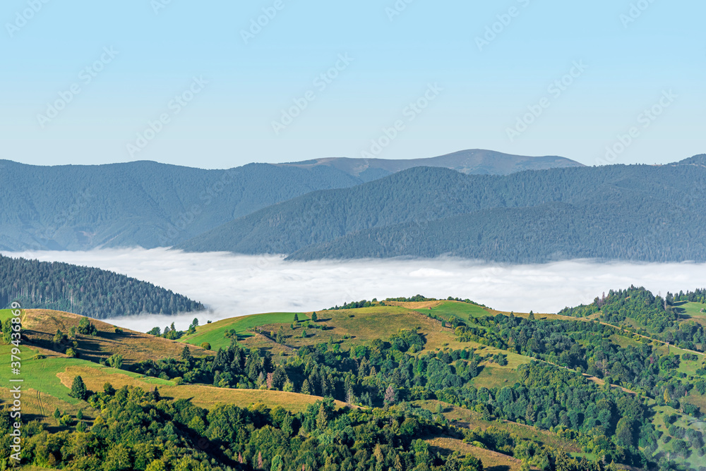 View of the mountain landscape and the mist-shrouded valley. Carpathians. View of the mountain landscape and the mist-shrouded valley. Carpathians.