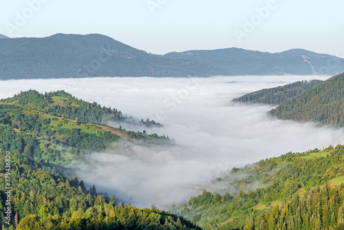 View of the mountain landscape and the mist-shrouded valley. Carpathians.