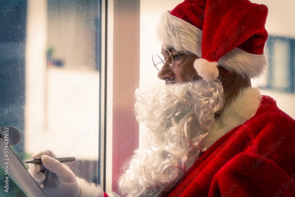 santa claus making his gift list santa claus making his gift list