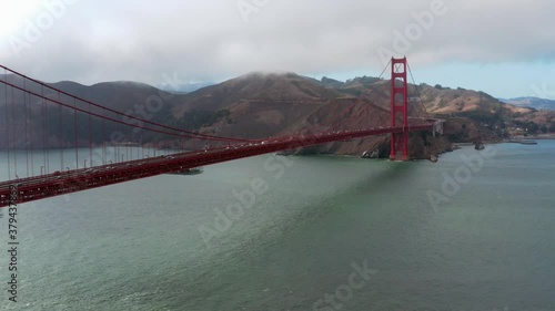 Wallpaper Mural Aerial: San Francisco Golden Gate Bridgeand cars moving through traffic in a cloudy day. Flying forward Torontodigital.ca