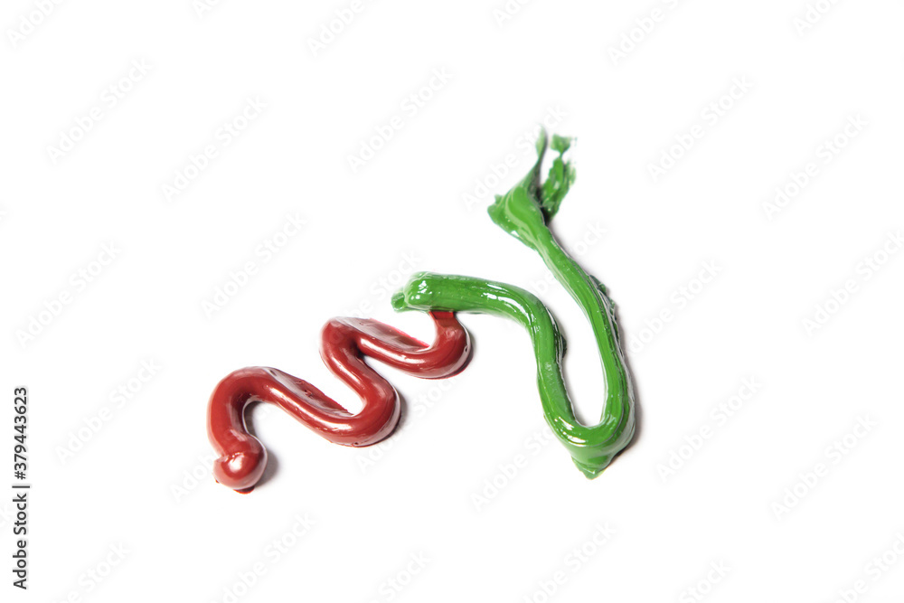 Red and green paint on a white background. A combination of two colors. Red and green paint on a white background. A combination of two colors.