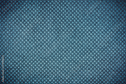 Blue grunge dotted paper fabric texture closeup photo background.