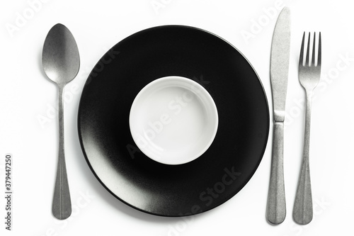 individual crockery and cutlery set on a white table