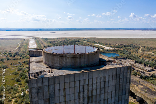 Monolithic reinforced concrete structure of an abandoned nuclear power plant on the background of a man-made landscape. Side view. Shooting from a drone. photo