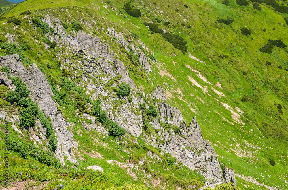 Sharp rocks with big rocky boulders on summer mountain slope of Spitz (Spytsi) mountain. Chornohora ridge, Carpathian mountains, Ukraine. Sharp rocks with big rocky boulders on summer mountain slope of Spitz (Spytsi) mountain. Chornohora ridge, Carpathian mountains, Ukraine.