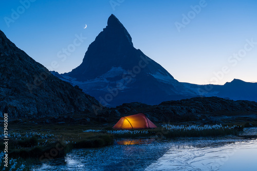 A tent at the Riffelsee, with a view at the famous Matterhorn, in the evening.