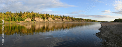 Summer panorama of the Northern taiga river.