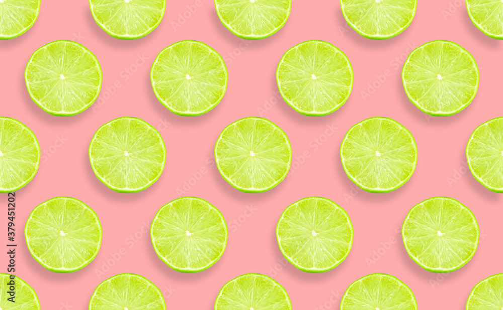 Creative pattern made with green lime on pink background.