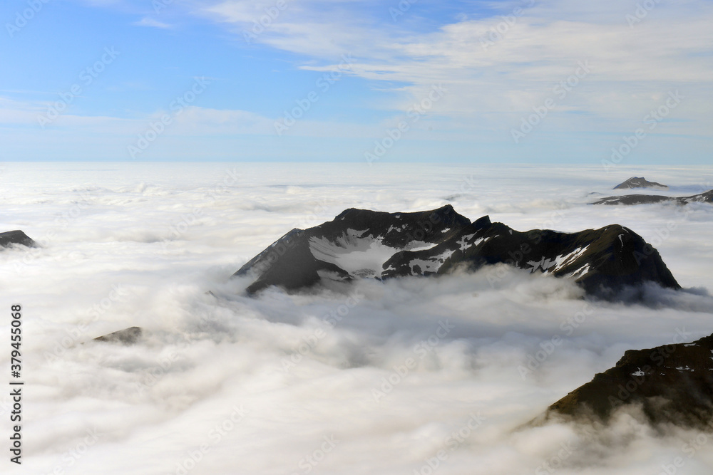Mountain peaks among dense clouds. Norway