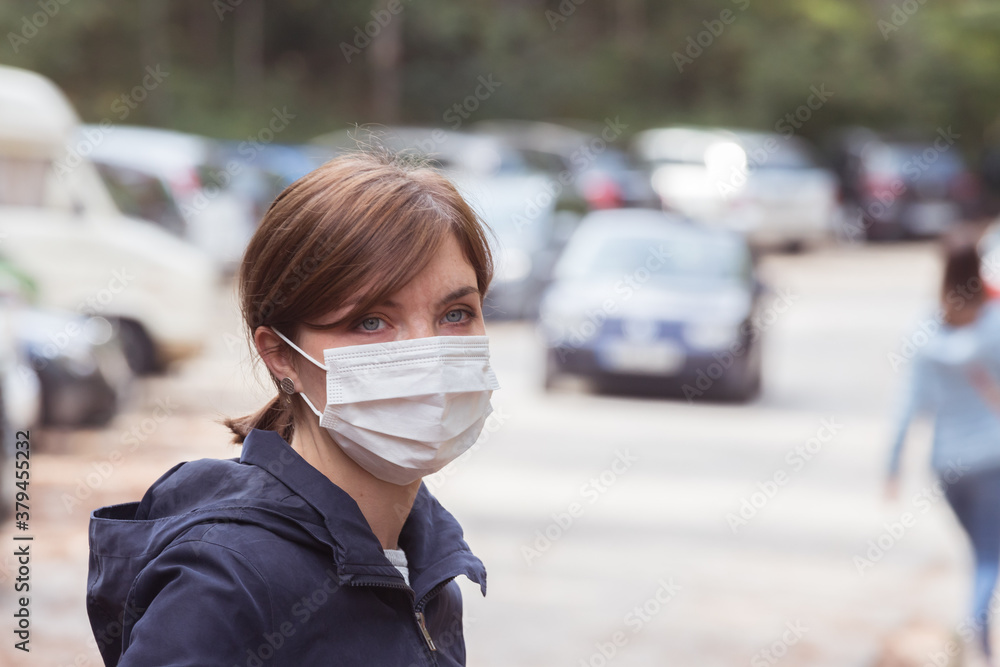 Flue and corona safety concept. Woman wearing face mask to protect herself, outdoors Flue and corona safety concept. Woman wearing face mask to protect herself, outdoors