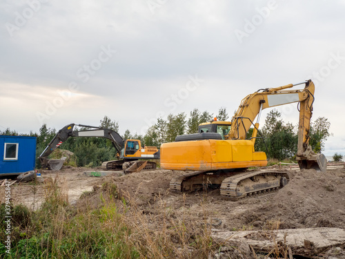 Excavator digs the ground for the foundation and construction of a new building