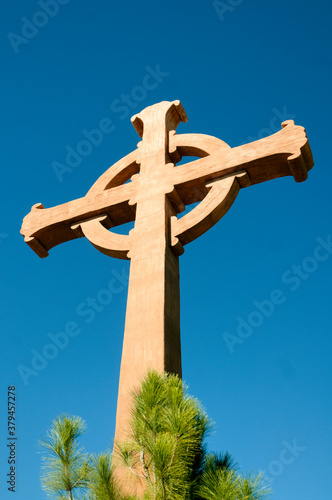 Wood Cross at Monastery backed by Blue sky photo